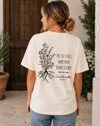 He Is Still Writing Your Story Comfort Colors Christian Shirt, Hebrews 12:2 Floral Design