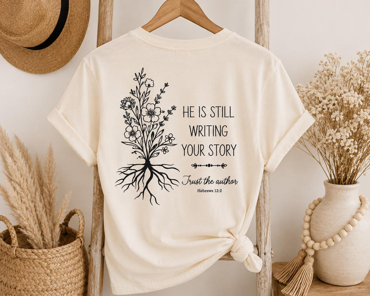 He Is Still Writing Your Story Comfort Colors Christian Shirt, Hebrews 12:2 Floral Design